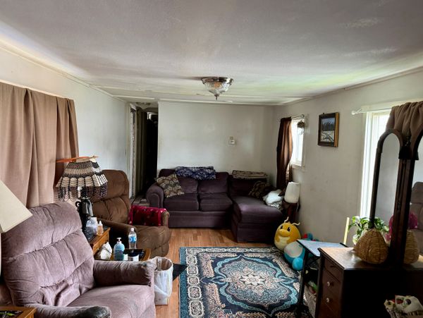Cozy living room with plush seating, patterned rug, and soft lighting.
