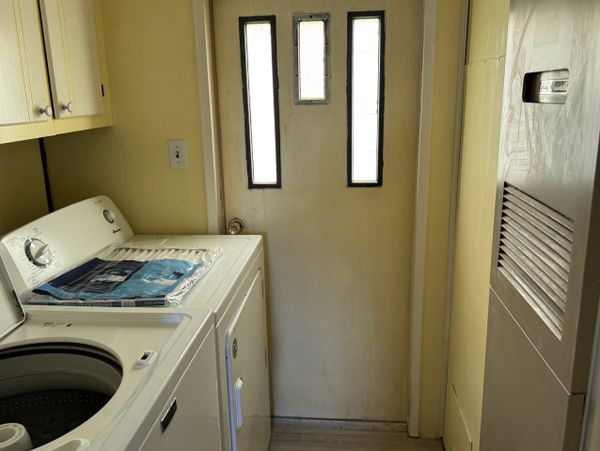 Compact laundry room with washer, dryer, and utility closet.