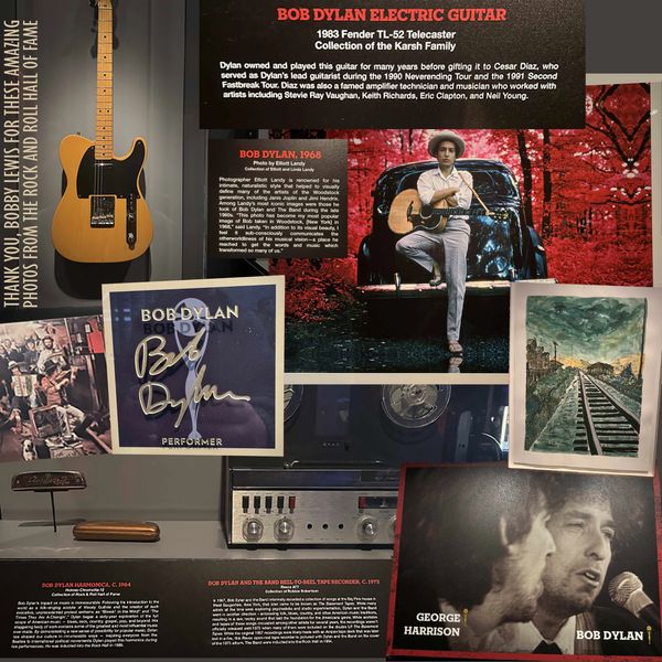 Display of Bob Dylan's electric guitar, photos, and memorabilia at the Rock and Roll Hall of Fame.