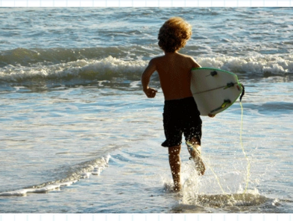 Boy running into the surf