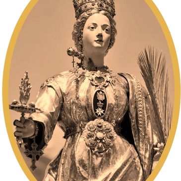 Statue of a crowned female saint holding a cross and palm branch in ornate robes.