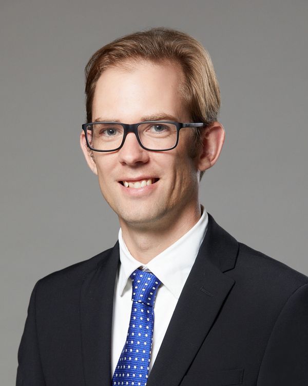 Professional man wearing glasses and a suit.