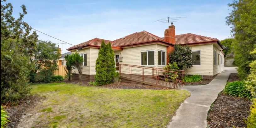 Single-story house with a red tiled roof and a wheelchair ramp.