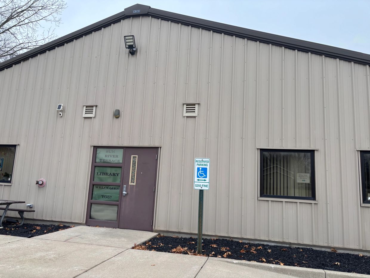 Exterior of a metal building with a library entrance.