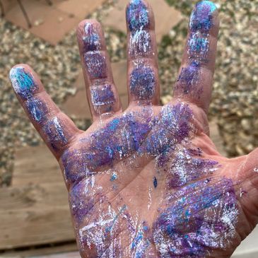 Colors on the artist's hand after painting.