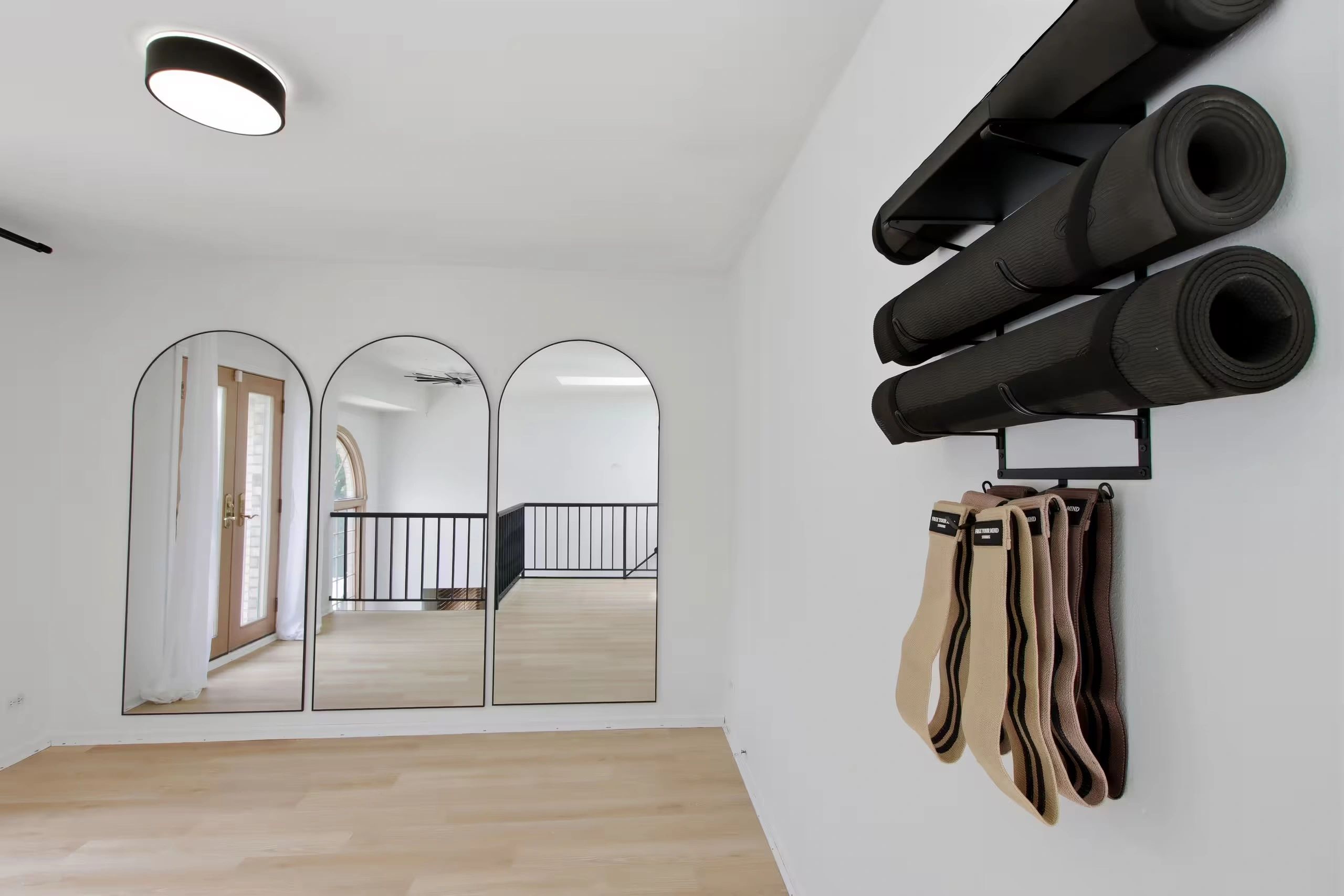 Minimalist workout room with yoga mats and resistance bands.