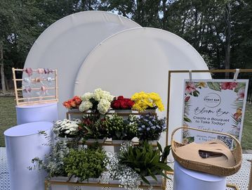 Flower arrangement and bouquet setup at an event.