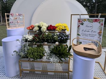 Flower arrangement and bouquet setup at an event.