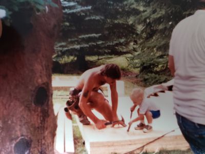 Brandyn and his father teaching him to use a hammer at age three. 