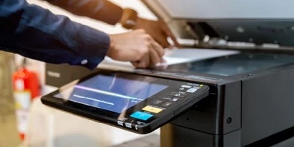 Person scanning document on a modern copier.