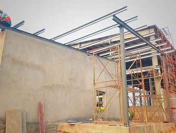 Construction site with steel framework and concrete walls under progress.