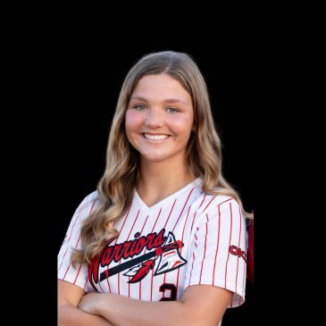 Smiling young female athlete in a Warriors sports jersey with arms crossed.
