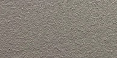 Close-up of a rough textured gray surface.