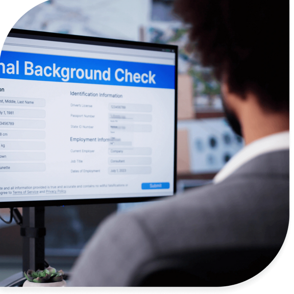 Person completing an online national background check form on a computer.