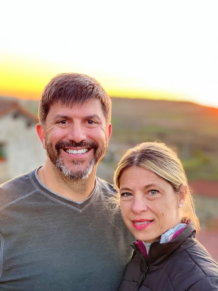 People with beautiful teeth smiling in front of a sunset