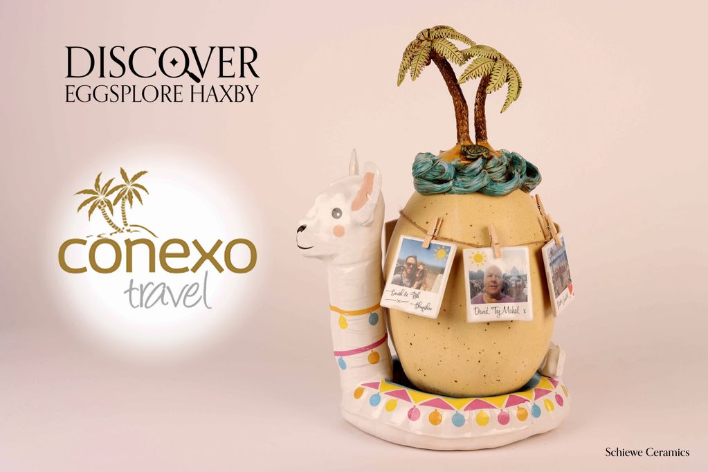 Schiewe Ceramic sculpture of an egg sitting on inflatable llama with an island on top and photos.