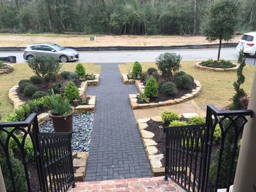 Residential sidewalk with lush green lawn and neatly edged border