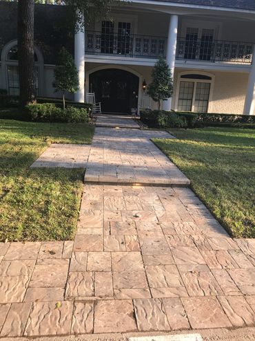 Custom stone pathway connecting outdoor living spaces in backyard