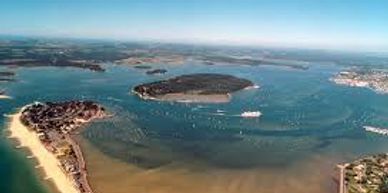 Aerial view of a coastal area with islands and boats in the water.