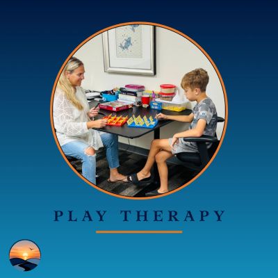 Woman and boy playing a game in play therapy.