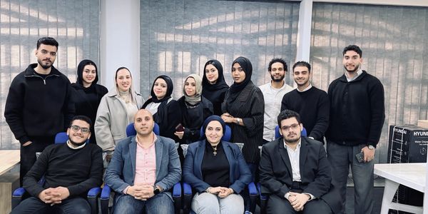 Group photo of young professionals in an office setting.