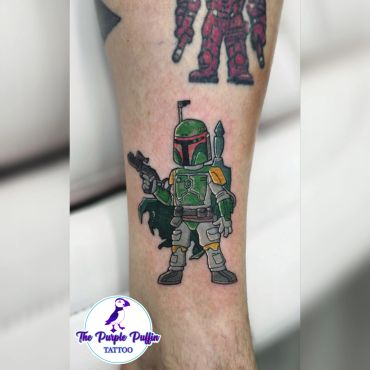 Colorful Boba Fett tattoo on leg.