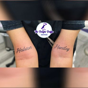 Matching names tattooed on each wrist.