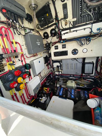 Compact organized electrical control panel with batteries and wiring.