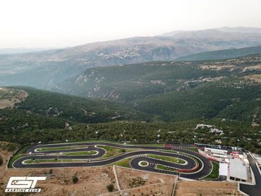 Full birds eye view of the race track with mountains.