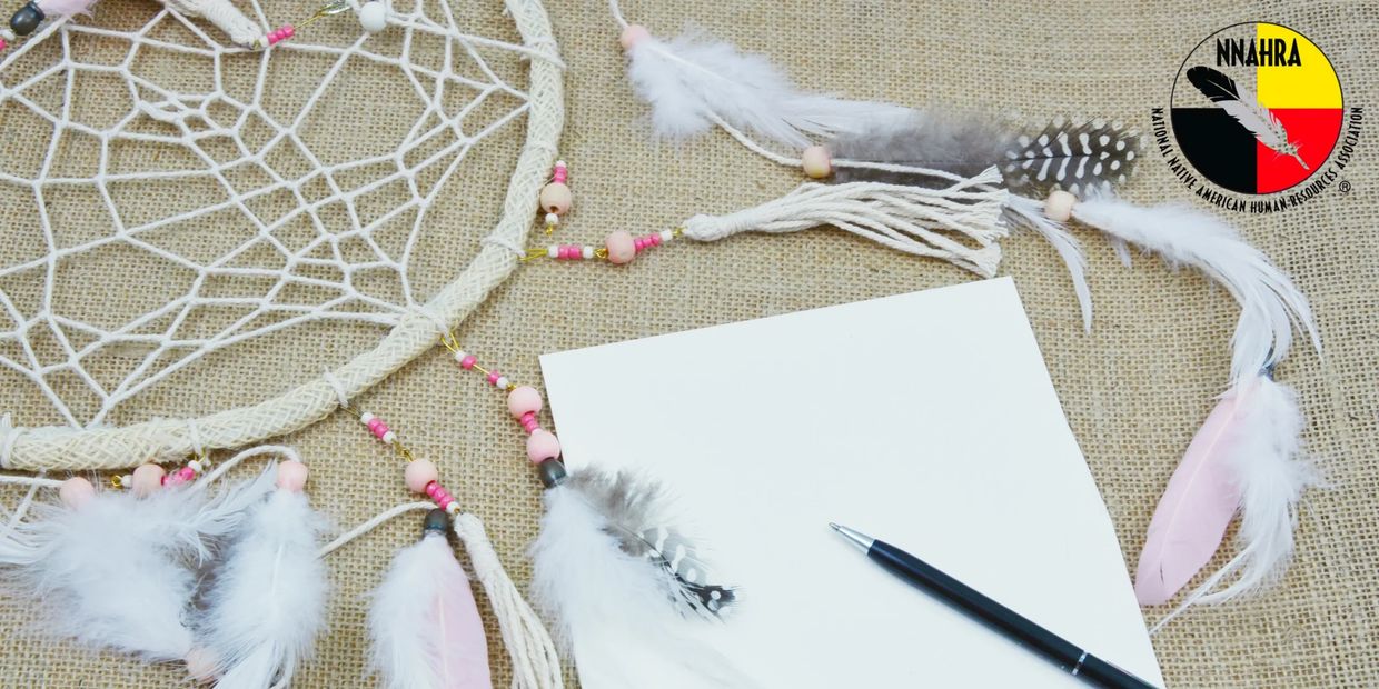 Dreamcatcher with blank paper and pen on burlap.