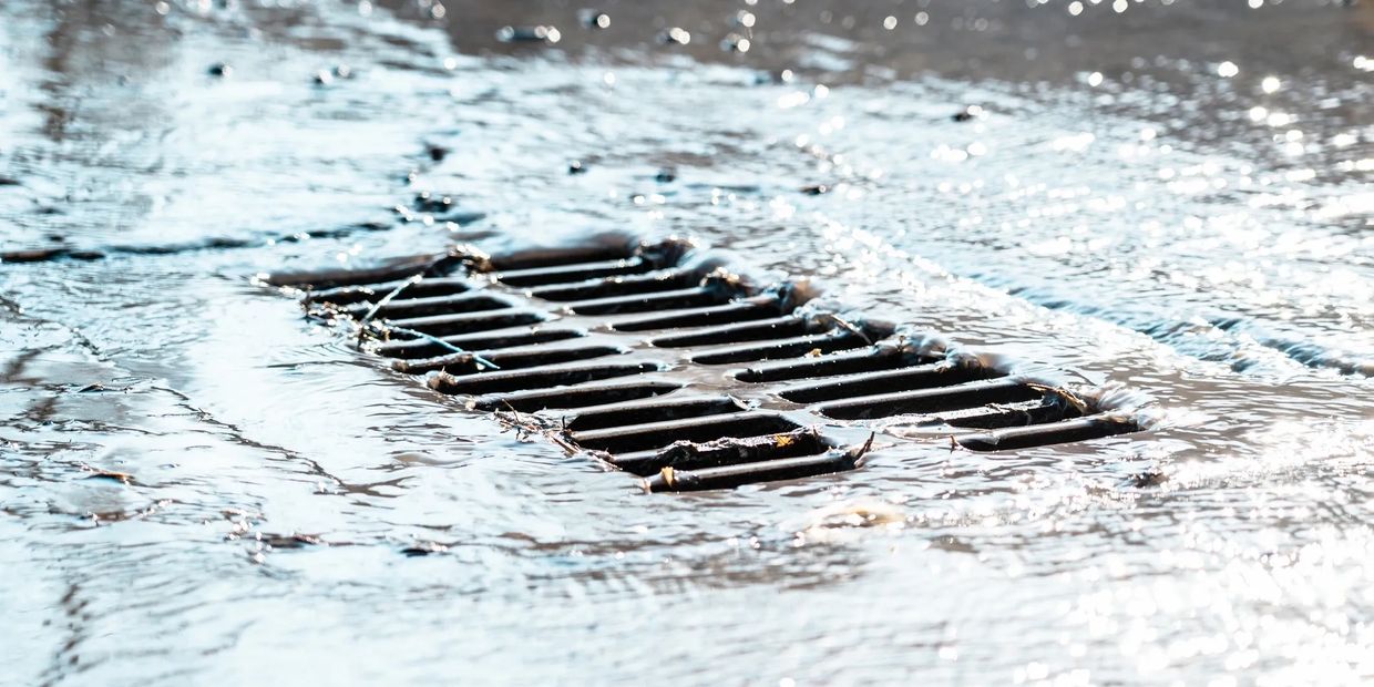 Water flowing into a stormwater inlet grate.