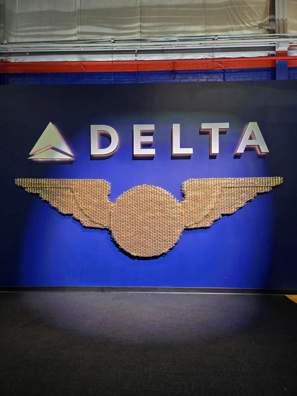 Delta Airlines logo and wing emblem displayed on a blue wall.
