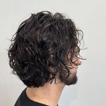 Chin-length curly cut with defined curls and balanced shape.