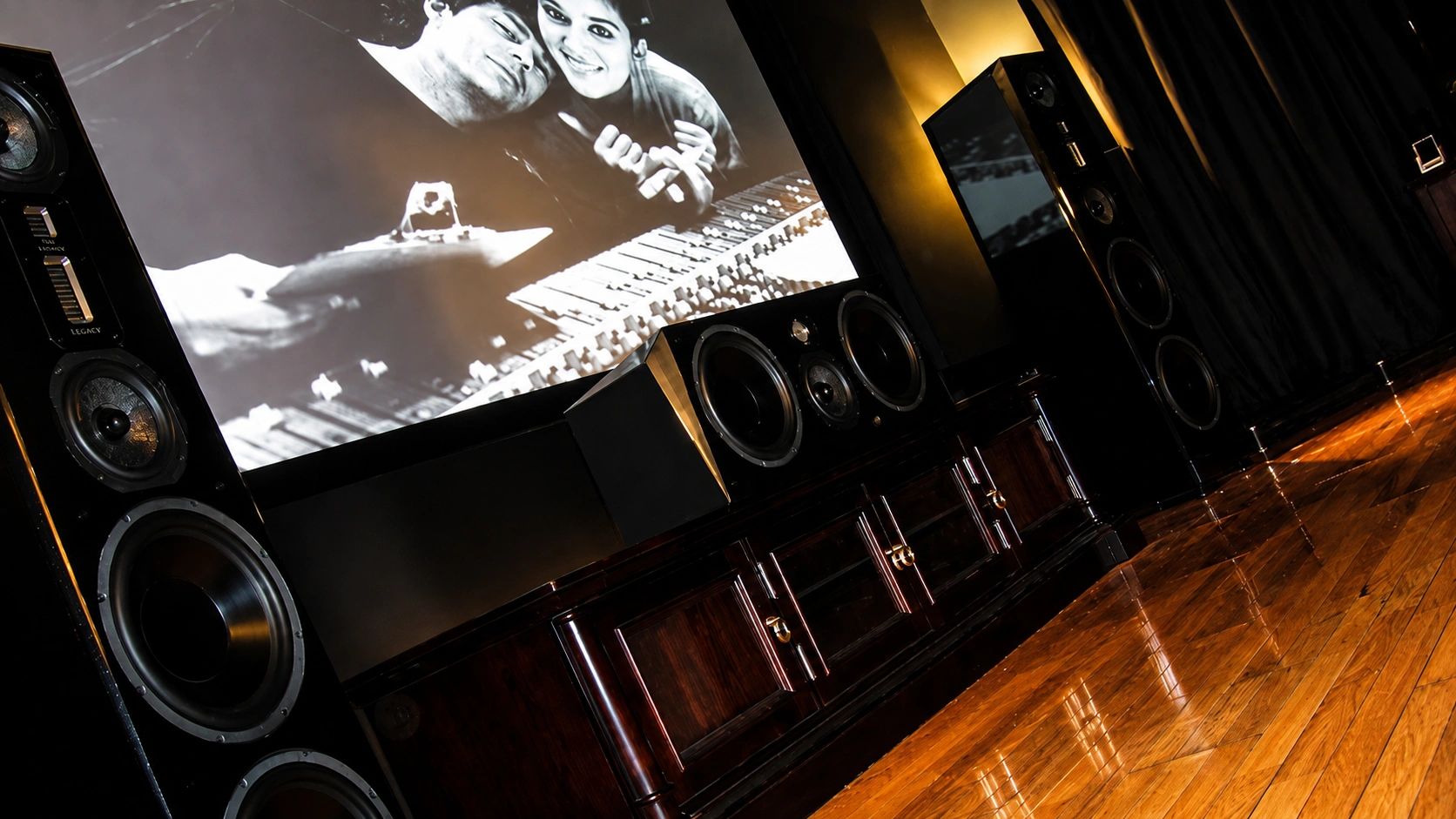 Home theater setup with large speakers and vintage movie projection.