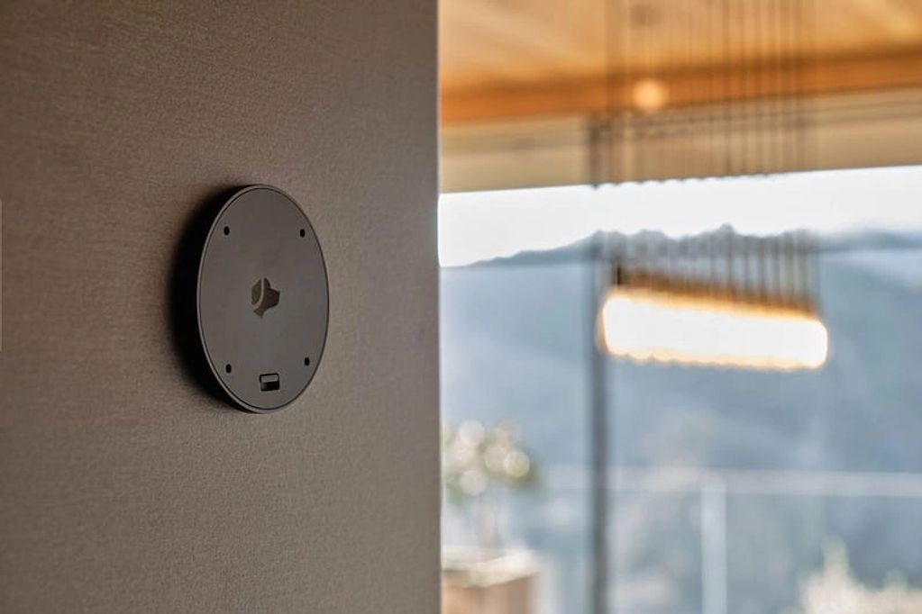 Small circular device mounted on a wall.