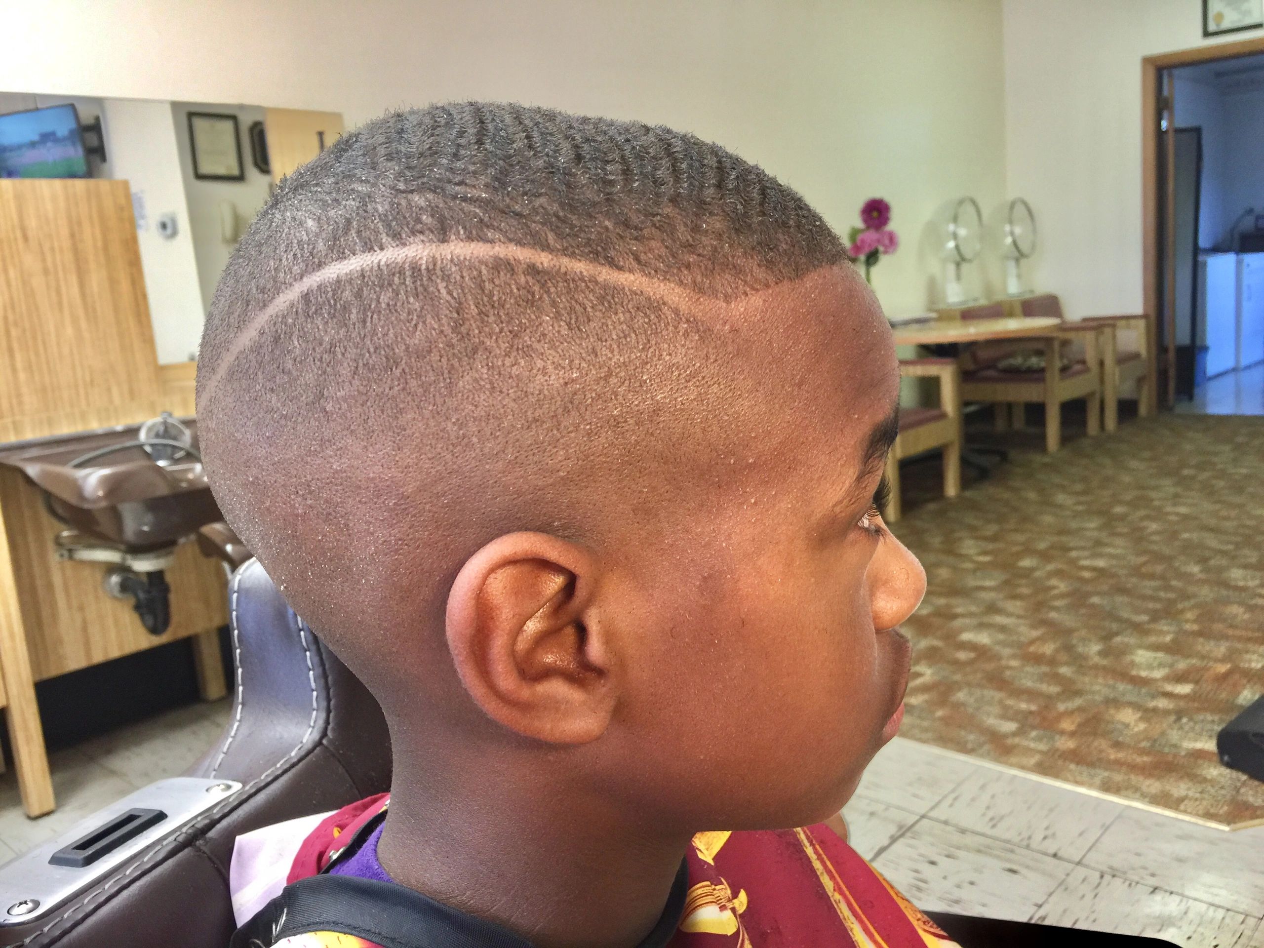 Close-up of a fresh haircut with a wave pattern and design line.
