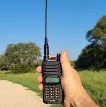 Using a walkie-talkie on a path outdoors