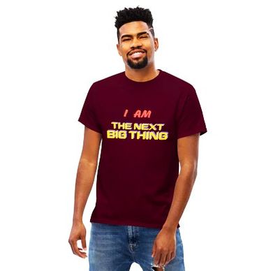Man wearing a maroon t-shirt with the text 'I AM THE NEXT BIG THING'.