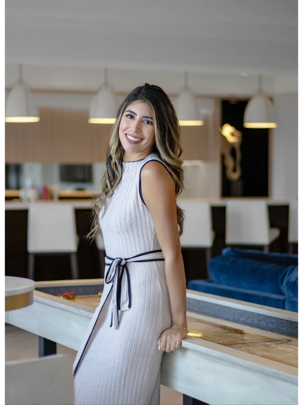 Portrait of interior designer Eva Franco in front of a luxury multi-family lounge. 