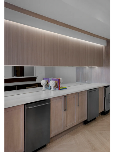 Contemporary recessed lighting detail amplifying the cabinetry detail.