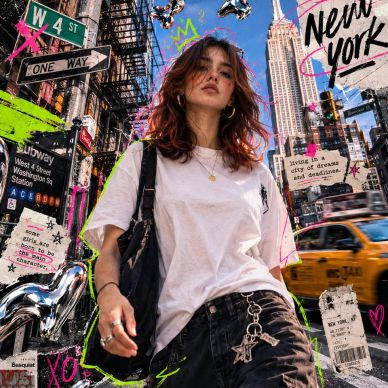 Young woman in New York City street with colorful graffiti.