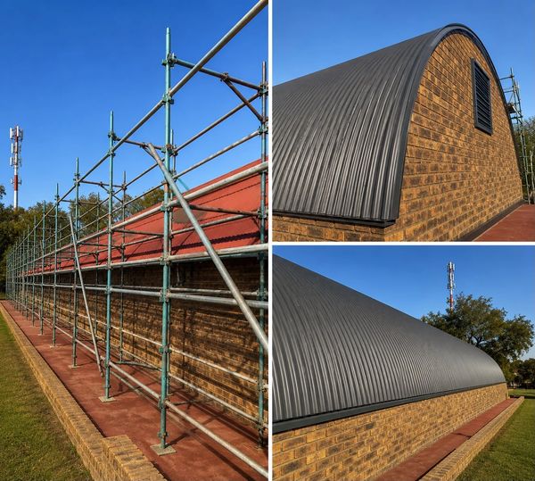 Scaffolding set up alongside a brick building with a curved metal roof under clear blue skies.
