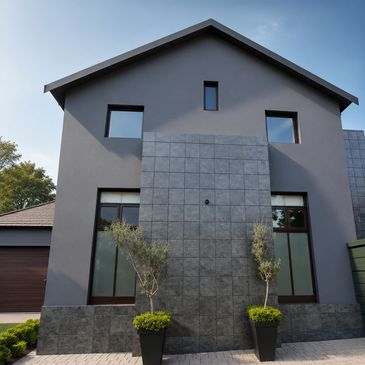 A modern residential home featuring a sleek charcoal-grey exterior with clean architectural lines an