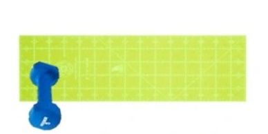 Blue dumbbell on a green exercise mat with grid lines.