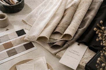 Various fabric samples and color swatches arranged on a table.