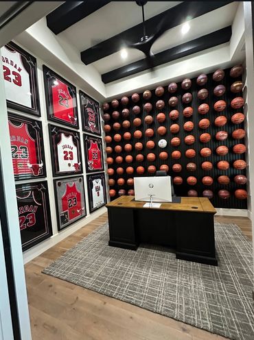 Office with basketballs and framed Michael Jordan jerseys.