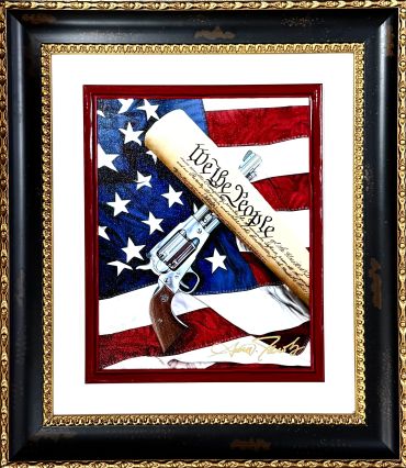 Framed art with American flag, revolver, and Constitution scroll.