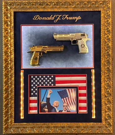 Framed display of two gold guns, an American flag, and a photo of Donald Trump.
