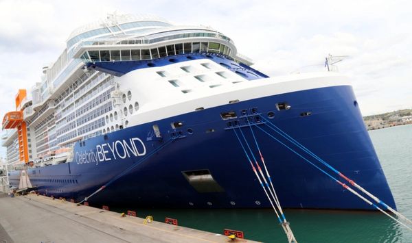 a large cruise ship docked at a dock