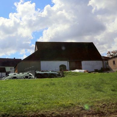 a car parked in front of a house on a hill